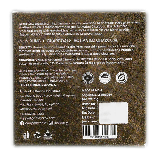 Back label of Cowpathy Cow Dung Charcoal Soap detailing ingredients, benefits, manufacturing process, and disclaimers. Highlights include 23% activated charcoal from Indigenous cow dung, moisturizing herbs, shea butter, essential oils, and Grade 1 soap base. Text explains the Pyrolysis method and benefits such as acne control, detoxification, and scalp soothing. Includes contact details, barcode, and product licensing