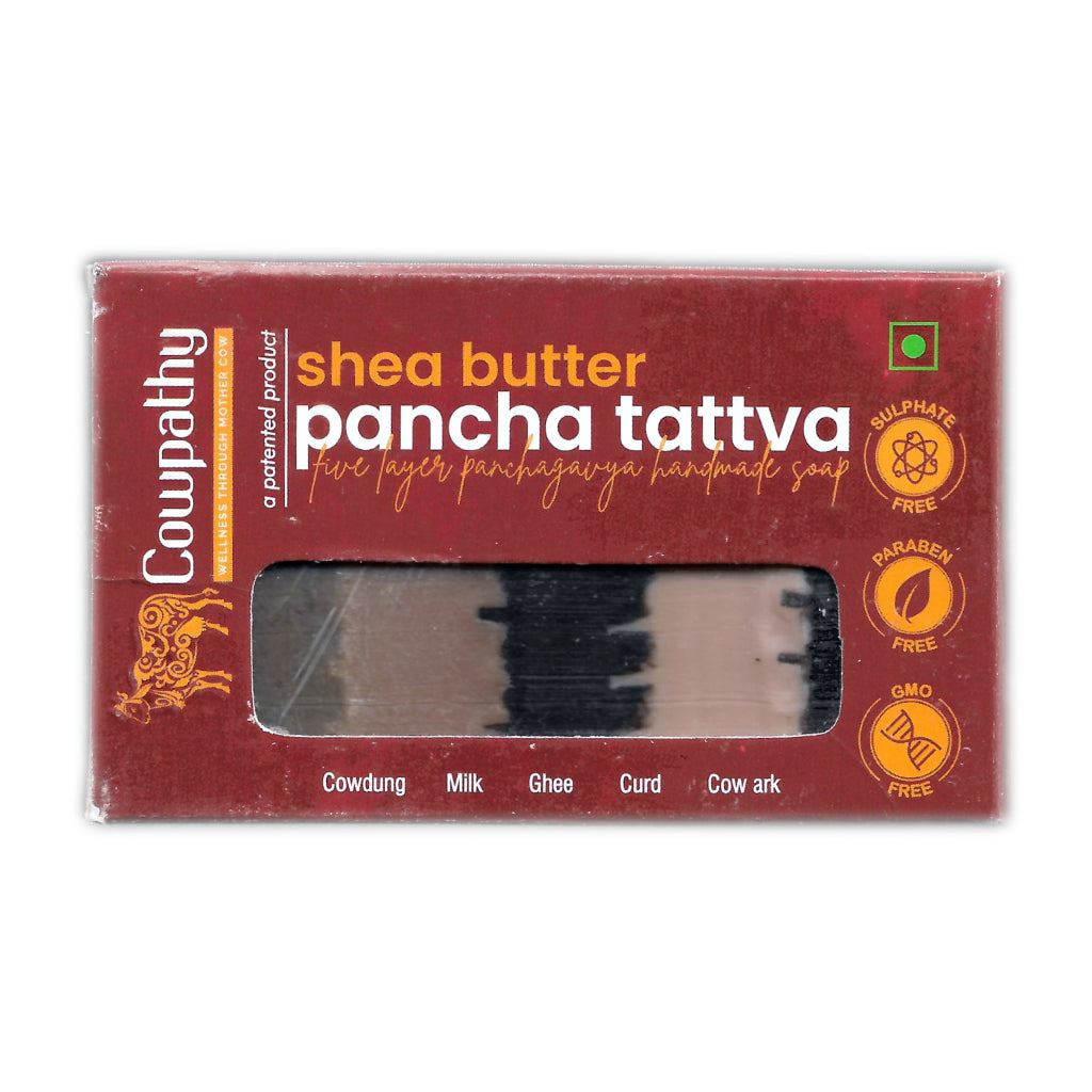 Cowpathy Shea Butter Pancha Tattva Soap package with maroon design, showcasing its five-layer handmade soap made from cowdung, milk, ghee, curd, and cow ark. Labels highlight sulphate-free, paraben-free, GMO-free attributes, and a vegetarian symbol. A window reveals the multicolored layered soap inside.