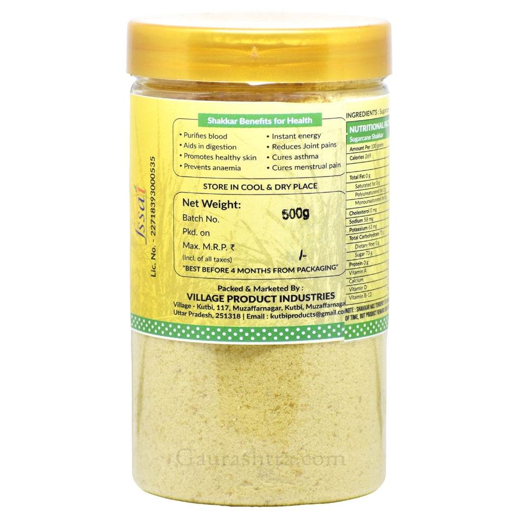 A yellow-lidded container of “Jaggery Powder” by Village Product Industries. The label lists extensive health benefits such as blood purification, digestive aid, skin enhancement, anemia prevention, and relief from joint pain, asthma, and menstrual discomfort. Nutritional data per 100g and storage instructions are printed alongside the brand’s address and contact details. The packaging also emphasizes it’s made from sugarcane and best consumed within 4 months.