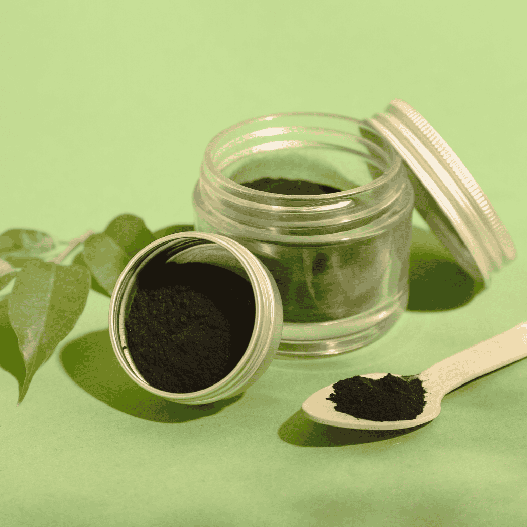 Black tooth powder in a container lid