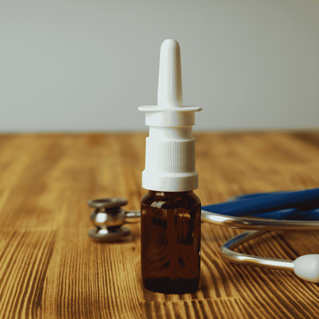 A glass dropper bottle placed on a wooden table