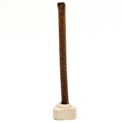 Single brown cow dung dhoop stick placed upright on a white base—crafted with natural material for spiritual rituals and eco-friendly indoor use.