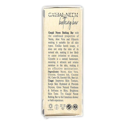 Back panel of Gavyadhara Gaujal Glycerin Neem Soap highlighting key Ayurvedic ingredients—Neem, Aloe Vera, Glycerin, and Gomutra Ark. Describes moisturizing and skin-brightening benefits, with natural oils that protect against dryness. Includes sulfate-free, cruelty-free, and eco-friendly icons, along with detailed usage notes for a luxurious bathing experience.