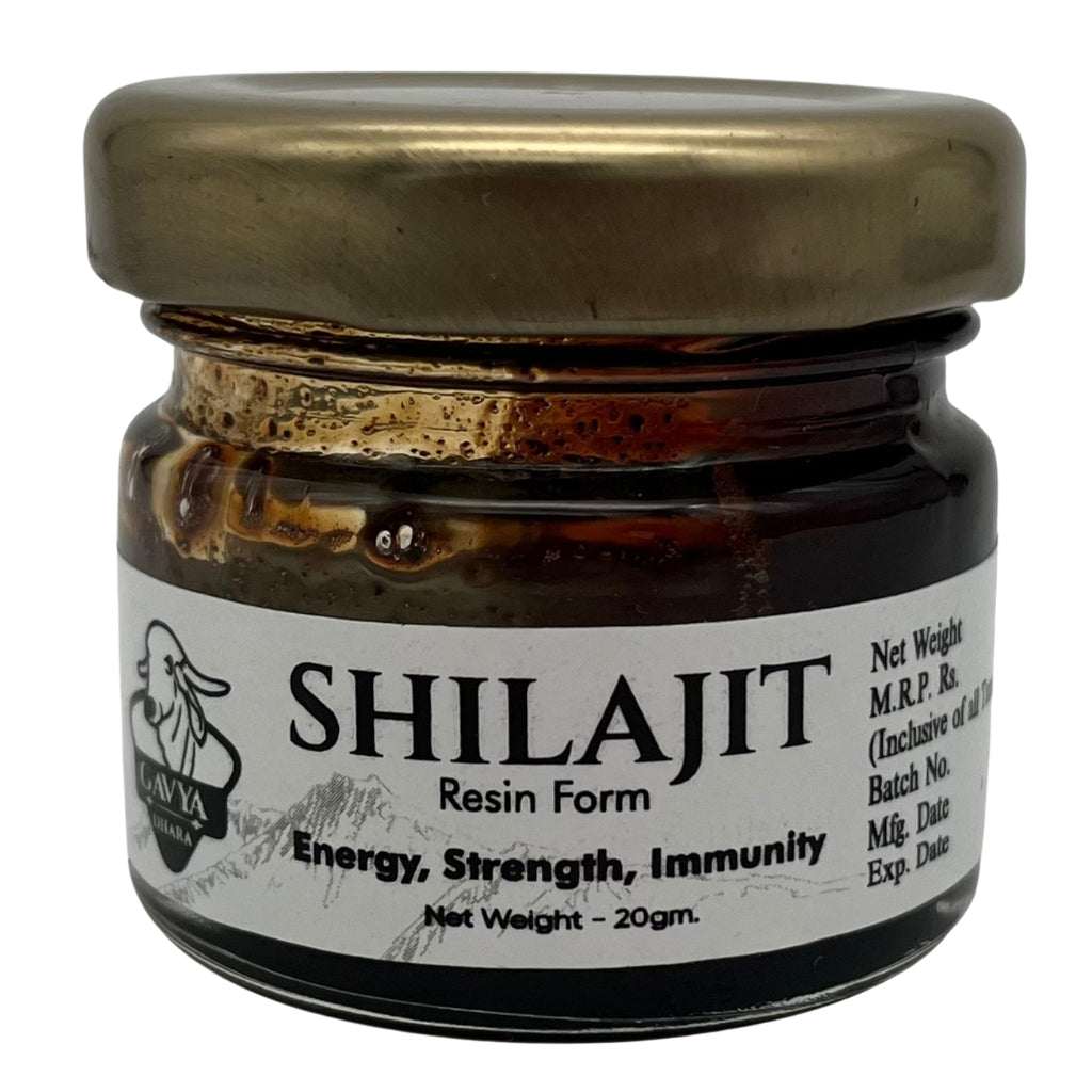 Small jar of Gavya Dhara Shilajit Resin Form with metallic lid, labeled “SHILAJIT Resin Form – Energy, Strength, Immunity.” Contains 20 grams. Front label also includes M.R.P., manufacturing and expiry dates, and batch number details. Goat icon and Gavya Dhara branding featured prominently, emphasizing Ayurvedic vitality.