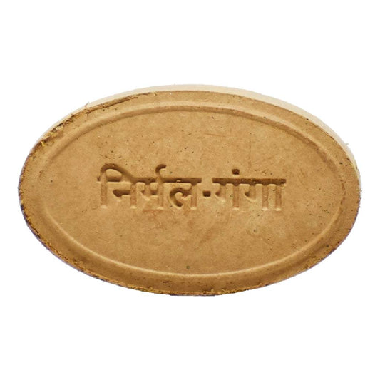 Oval-shaped Gou Ganga Nirmalganga Multani Mitti Soap embossed with “निर्मल गंगा” in Hindi script. The soap’s earthy hue and minimalist design evoke Ayurvedic purity and traditional cleansing rituals linked to the sacred Ganges River.