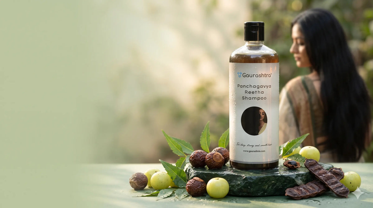 Gaurashtra reetha shampoo placed on a solid stone. A traditional Indian woman  with healthy hair is in the background.