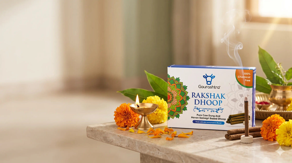 Gaurashtra Rakshak Dhoop cow-dung incense box displayed with a traditional brass diya, marigold flowers, and a burning dhoop stick in a serene Indian pooja setting.